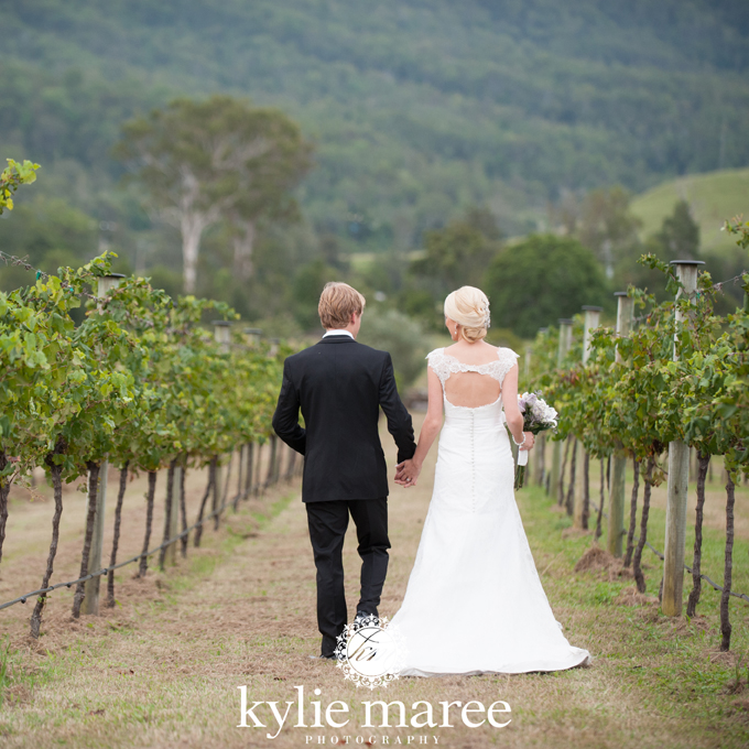 Renee and Corey walking through vineyard